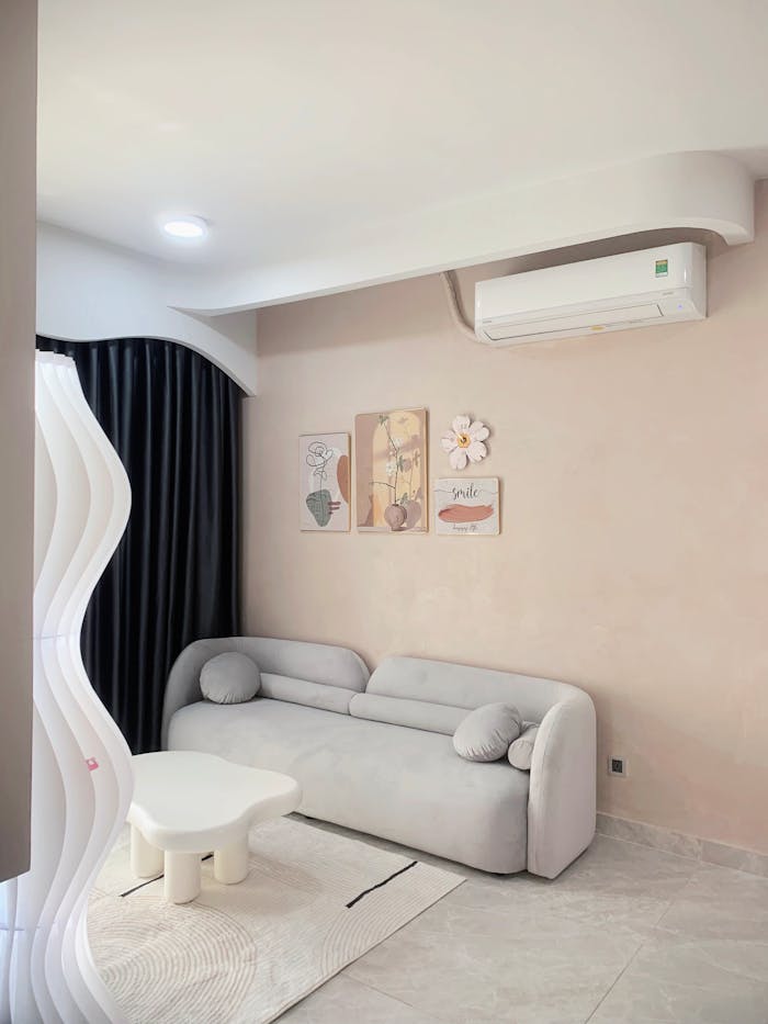 Elegant minimalist living room with a cozy sofa and abstract art for a serene ambiance.